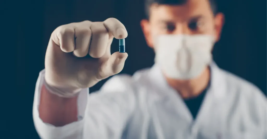 Doctor holding antibiotic capsule wearing mask and gloves, representing antibiotic resistance awareness