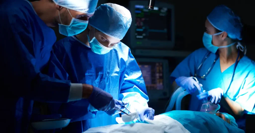 Cardiac surgical team performing coronary artery bypass surgery in operating room